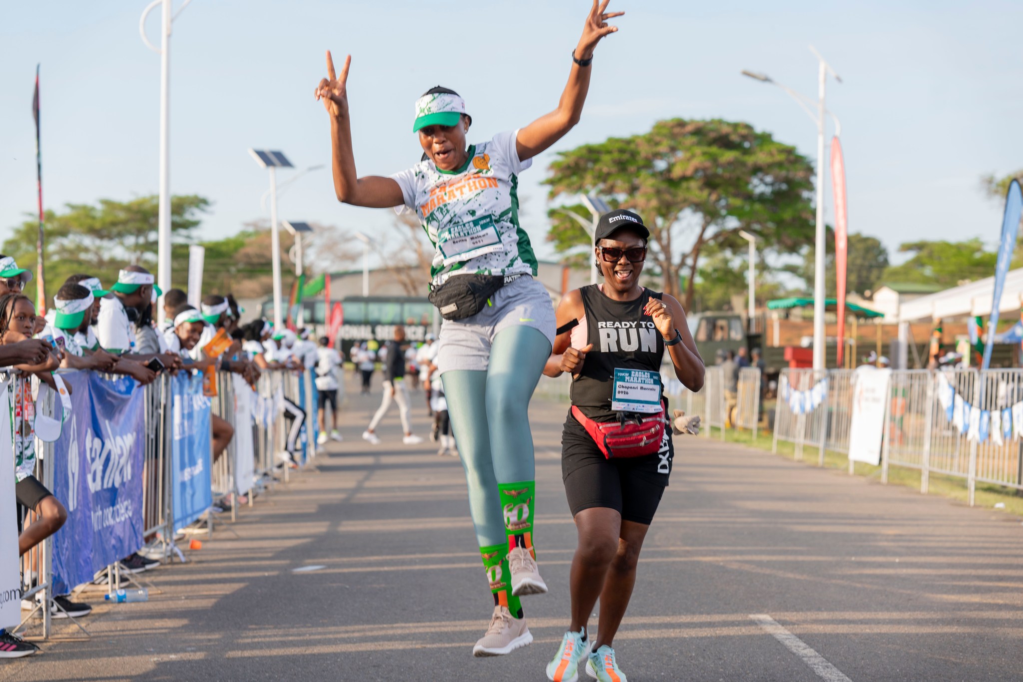 Runners celebrating at the marathon finish line with medals