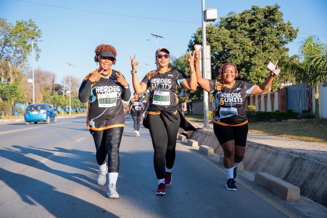 Three women runners celebrating on the course